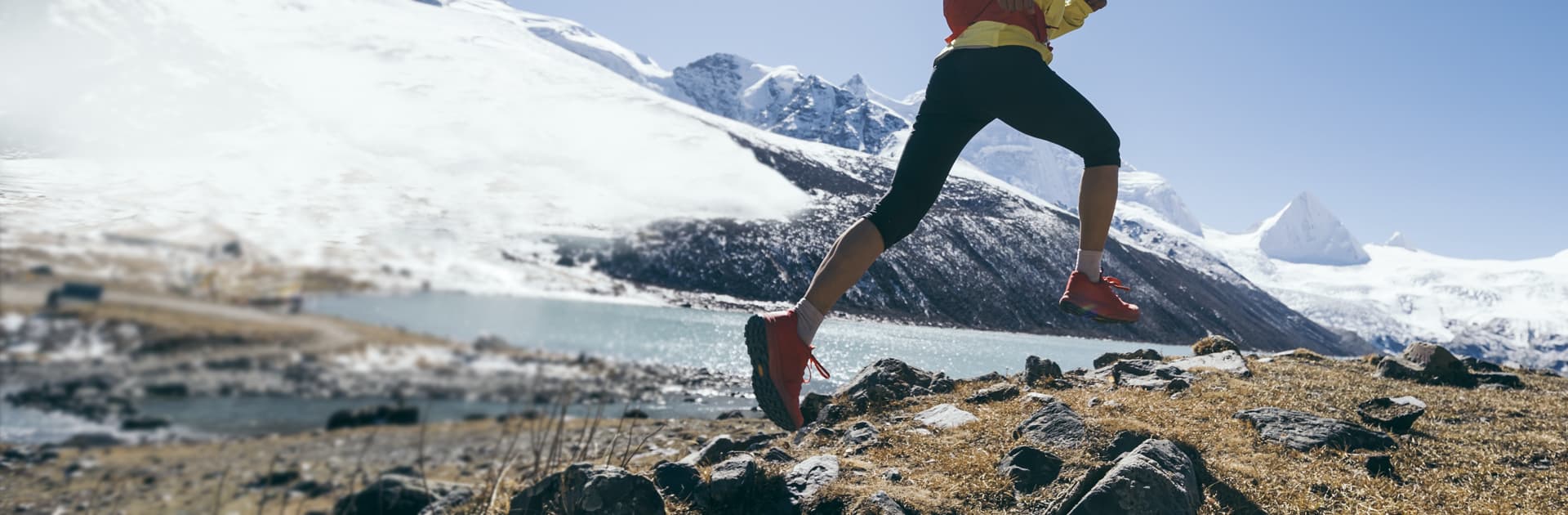 Explorer jumping in snowy mountains